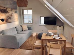 a living room with a couch and a table at BoHouse apartment No1 in Preila