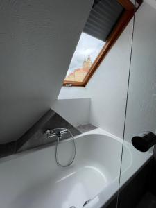 a white bath tub in a room with a window at Hotel Restaurant zur Post in Melk