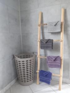 a towel ladder with four towels and a trash can at La P'tite Maison... in Sickert