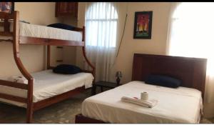 Postel nebo postele na pokoji v ubytování Veranera Hostal