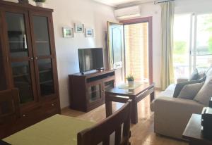 a living room with a couch and a tv at 2 bed apartment with pools and spa in Vera