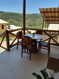 a table and chairs on a balcony with a view at Casa Charme de Lençois in Lençóis