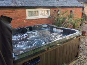 a hot tub in the backyard of a house at The Old Schoolhouse in Whitstable
