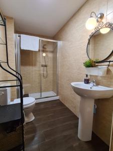 a bathroom with a sink and a shower and a toilet at La casita de voto in Bádames