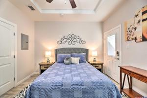 a bedroom with a blue bed with two night stands at Sleek Edinburg Home Near Shopping and Hiking! in Edinburg
