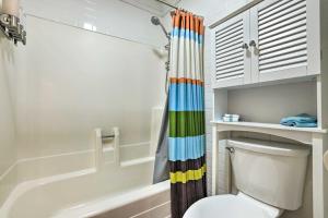 a bathroom with a toilet and a colorful shower curtain at Walk to Giant Steps Lift - Brian Head Condo in Brian Head +17 photos