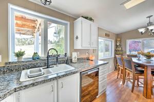 a kitchen with a sink and a table with chairs at John Day Lakehouse with a Great Outdoor Space! in John Day