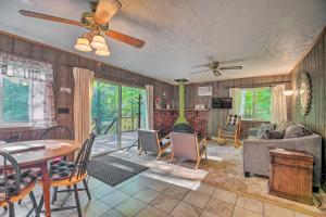 a living room with a table and a couch at Cozy Adirondacks Cabin Walk to Lake Eaton! in Jay