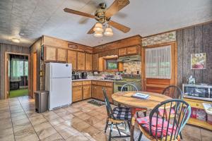 a kitchen with a table and a ceiling fan at Cozy Adirondacks Cabin Walk to Lake Eaton! in Jay