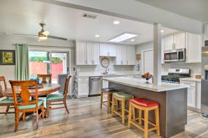 a kitchen and dining room with a table and chairs at San Marcos Home with Pool Access - Walk to Lake! in San Marcos