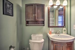 a bathroom with a sink and a toilet and a mirror at Waterfront Onamia Retreat with Dock and Fire Pit! in Onamia +21 photos