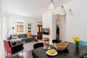 a living room with a table and a couch at The Yellow House by LovelyStay in Funchal