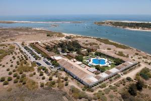 an aerial view of a resort next to the water at Vila Gale Albacora in Tavira