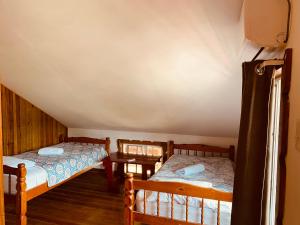 a room with two beds and a table at Hotel Caribbean View in Bastimentos +37 photos