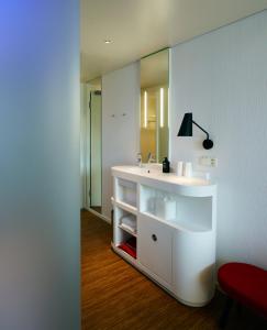 a bathroom with a sink and a mirror at citizenM Zürich in Zurich