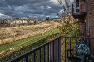 a balcony of a house with a view of a field at Bear Claw 312 - Ski-in Ski-out Condo! in Steamboat Springs
