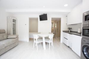 a kitchen and living room with a table and a couch at La Riega in Potes