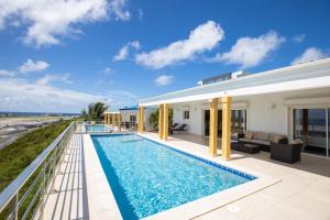 a swimming pool in the backyard of a house at Reflection Z 5 Star Villa in Maho Reef