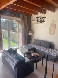 a living room with a couch and a table at Kiotari Stone House in Gennadi