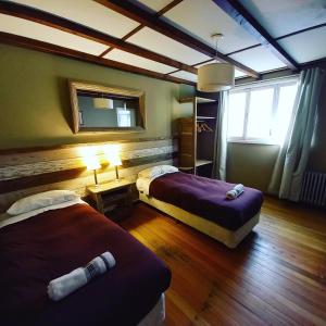Säng eller sängar i ett rum på Bariloche Hostel