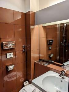 a bathroom with a sink and a shower at Aussen Alster Hotel in Hamburg +49 photos