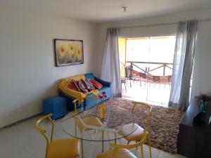 a living room with a blue couch and chairs at Apto Villa das Aguas in Estância +16 photos