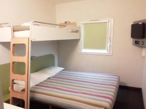 a bunk bed in a small room with a window at SUN1 Durban in Durban