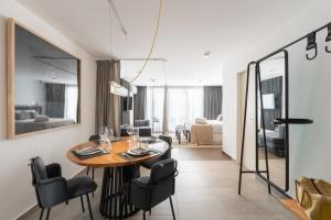 a dining room with a table and chairs and a living room at Stay Suites in Cordoba