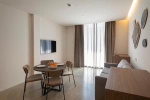 a living room with a couch and a table and chairs at Mon Suites Dau in Valencia
