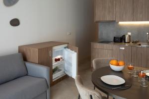 a small kitchen with a table and a small refrigerator at Mon Suites Dau in Valencia