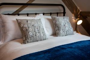 a bed with two pillows on top of it at Drovers Rest Farm Stay in Hay-on-Wye