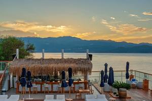 a restaurant with a table and chairs and a view of the water at Meis Exclusive Hotel in Kaş
