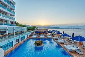 a pool on a cruise ship with chairs and umbrellas at Meis Exclusive Hotel in Kaş
