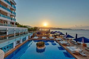 a pool on the deck of a cruise ship at sunset at Meis Exclusive Hotel in Kaş