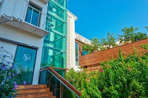 a home with a staircase leading to a balcony at Meis Exclusive Hotel in Kaş