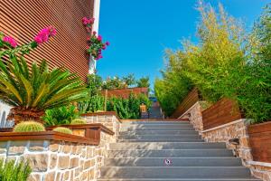 a set of stairs leading up to a building with plants at Meis Exclusive Hotel in Kaş