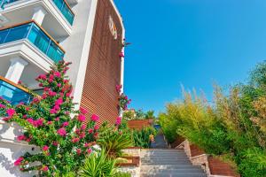 a stairway leading up to a building with pink flowers at Meis Exclusive Hotel in Kaş