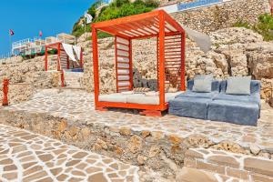 a wooden gazebo sitting on a stone path at Meis Exclusive Hotel in Kaş