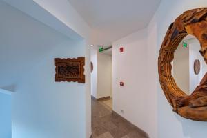 a room with a circular mirror on the wall and a hallway at Meis Exclusive Hotel in Kaş