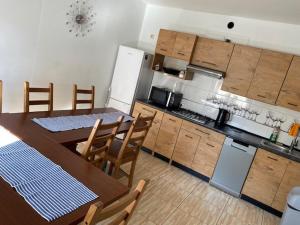 a kitchen with a wooden table and a table and chairs at aleSpanie in Olsztyn