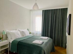 Postel nebo postele na pokoji v ubytování Borg Apt City Central