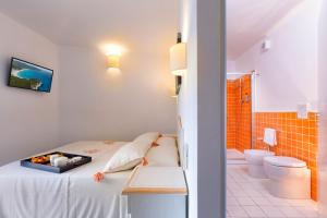 Posteľ alebo postele v izbe v ubytovaní Janas Hotel