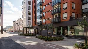 an empty street in a city with tall buildings at First Class-Annankatu in Pori