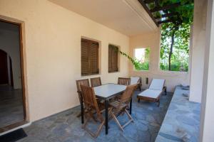 a patio with a table and chairs on a wall at SINI Apartments 3 in Kefalos