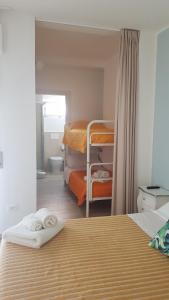 a bedroom with two bunk beds and a bathroom at Gli Oleandri in Porto San Giorgio