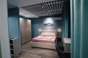 a bedroom with a bed and a desk and a sink at Novs Hotel Rooms in Gjirokastër