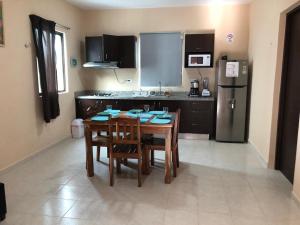 a kitchen with a table and chairs and a refrigerator at Apartamento Akamay 3 in El Cuyo +73 photos