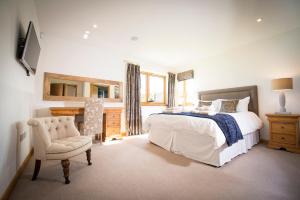 a bedroom with a bed and a chair and a mirror at Blue Sky Lodges. Atlas & Aurae in Croy