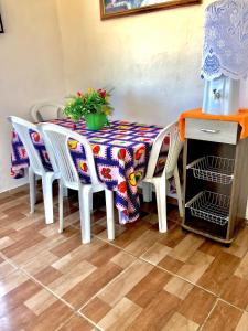 a dining room table with chairs and a table with at Villa D Mariscos in Barra de Santo Antônio