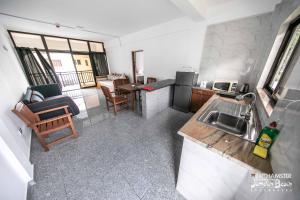 a kitchen with a sink and a counter top at Jamelah Beach Guest House in Anse aux Pins